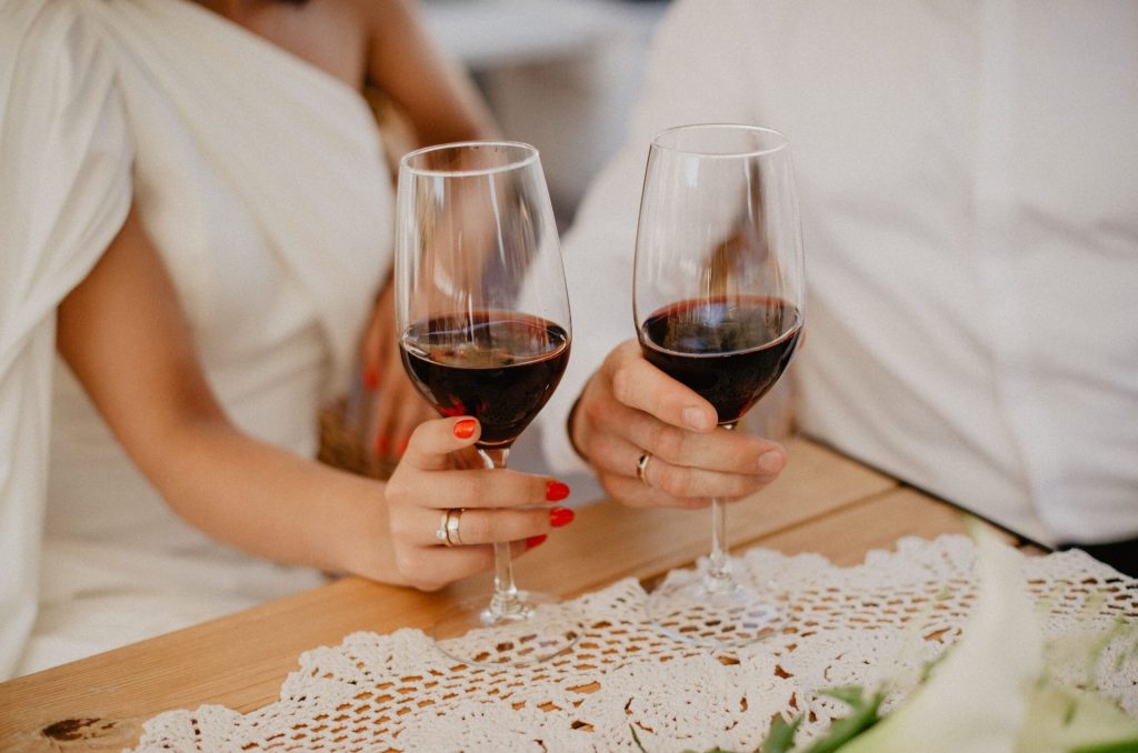 compressed-couple-holding-glasses-of-wine-close-up-2022-11-16-18-38-14-utc